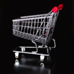 Red Handle Gray Shopping Cart on Black Background