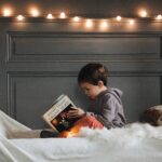 Boy in Gray Jacket Reading Book