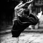 Woman in Black Skirt and White Long Sleeve Shirt Dancing Ballet