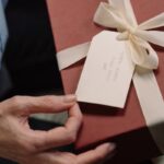 A Box of Gift with a Card and White Ribbon