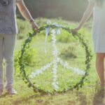 Two Person Holding White and Green Peace Wreath