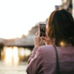 Woman Wearing Maroon Long-sleeved Shirt Holding Smartphone