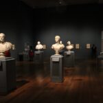 Assorted Busts on Gray Stand