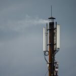 a cell phone tower with a sky background