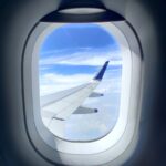 white and blue airplane wing