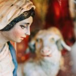 a statue of a woman and a sheep