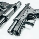 black semi automatic airsoft pistol on white textile