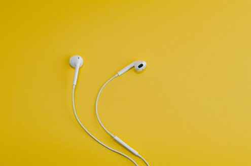 Apple EarPods on yellow surface
