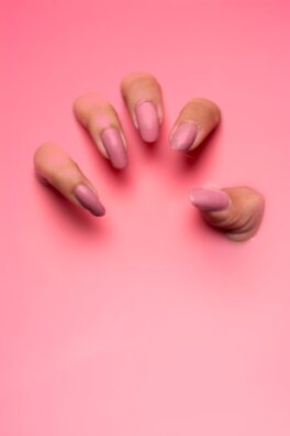 persons hand on pink surface