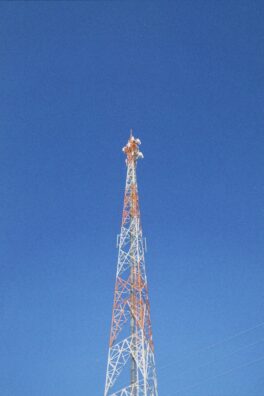 a very tall tower with a clock on it's side