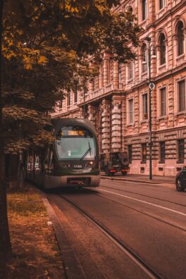 gray and black bus beside concrete building