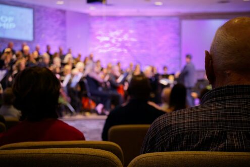 Audience watches a choir perform on stage.