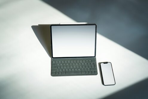 a tablet and a cell phone sitting on a table