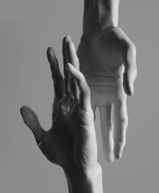 Two hands reaching up towards each other