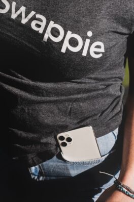 white iphone 4 on black and white adidas shirt