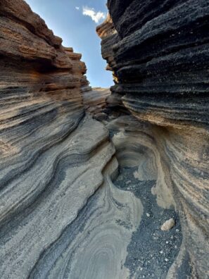 Explore the unique volcanic rock formations of Lanzarote's rugged landscape.