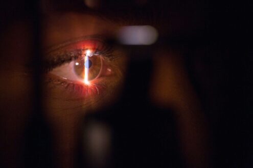 person with lighted cigarette in mouth