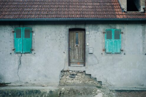 white concrete house showing closed door